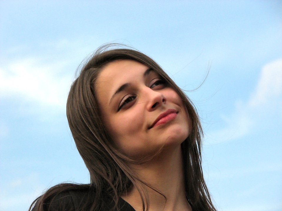 Closeup Of A Teen Girl With A Blue Sky