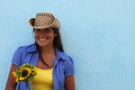 Free Stock Photo: A beautiful woman with a hat holding a sunflower