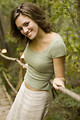 Free Stock Photo: A beautiful woman posing against a wooden railing