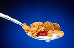 Free Stock Photo: A spoonful of cereal, milk and a berry