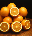 Free Stock Photo: Sliced and whole ambersweet oranges displayed in a bowl on a table