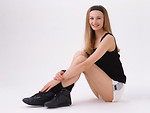 Free Stock Photo: A beautiful blonde sitting in exercise shorts isolated on a white background