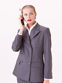 Free Stock Photo: A beautiful blonde businesswoman talking on a cell phone isolated on a white background