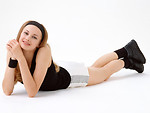 Free Stock Photo: A beautiful blonde in exercise shorts lying down isolated on a white background