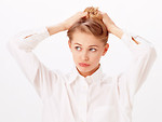 Free Stock Photo: A beautiful blonde fixing her hair isolated on a white background