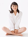 Free Stock Photo: A beautiful woman sitting with crossed legs isolated on a white background