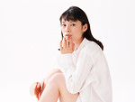 Free Stock Photo: A beautiful woman sitting isolated on a white background
