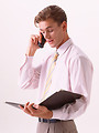 Free Stock Photo: A young business man in a tie talking on a cell phone  isolated on a white background