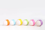 Free Stock Photo: A line of easter eggs with ribbons isolated on a white background