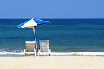 Free Stock Photo: Empty beach chairs and umbrella overlooking the ocean