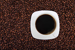 Free Stock Photo: A cup of coffee on a bean background