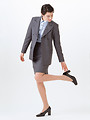 Free Stock Photo: A beautiful woman in a business suit fixing her heel isolated on a white background