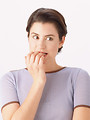 Free Stock Photo: A beautiful girl acting nervous isolated on a white background