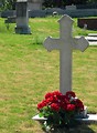 Free Stock Photo: A cross shaped grave stone in a cemetery.