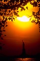 Free Stock Photo: Silhouette of the Statue of Liberty monument on Liberty Island at sunset