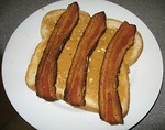 Free Stock Photo: A peanut butter and bacon sandwich on a white plate