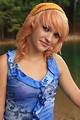 Free Stock Photo: A beautiful young woman posing by a lake
