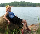Free Stock Photo: A beautiful young woman posing by a lake.