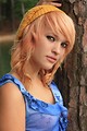 Free Stock Photo: A beautiful young woman posing against a tree by a lake