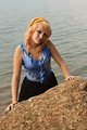 Free Stock Photo: A beautiful young woman posing by a lake