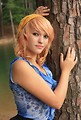 Free Stock Photo: A beautiful young woman posing against a tree by a lake