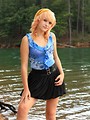Free Stock Photo: A beautiful young woman posing by a lake