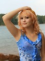 Free Stock Photo: Portrait of a beautiful young woman posing by a lake