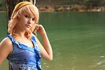 Free Stock Photo: A beautiful young woman posing against a tree by a lake