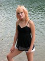 Free Stock Photo: A beautiful young woman posing by a lake