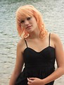 Free Stock Photo: A beautiful young woman posing by a lake