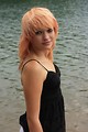 Free Stock Photo: A beautiful young woman posing by a lake