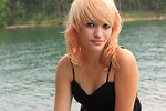 Free Stock Photo: Close-up portrait of a beautiful young woman posing by a lake