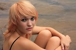 Free Stock Photo: A beautiful young woman posing by a lake
