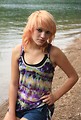 Free Stock Photo: A beautiful young woman posing by a lake