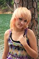 Free Stock Photo: A beautiful young woman posing by a lake