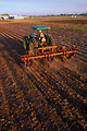 Free Stock Photo: A tractor pulling a stalk-puller on a farm field