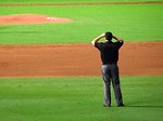 Free Stock Photo: A baseball umpire standing on a baseball diamond
