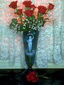 Free Stock Photo: A vase with a bouquet of red roses