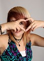 Free Stock Photo: A beautiful young woman making a heart symbol with her hands