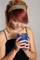 Free Stock Photo: A beautiful girl looking unhappily into a drink in a plastic cup
