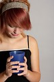 Free Stock Photo: A beautiful girl looking unhappily into a drink in a plastic cup