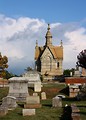 Free Stock Photo: A small mausoleum and tombstones at historic Oakland Cemetery in Atlanta, Georgia