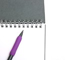 Free Stock Photo: A pad of paper and a pencil isolated on a white background