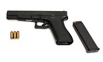 Free Stock Photo: A Glock 24 pistol with ammo on a white background