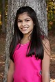 Free Stock Photo: A beautiful young girl posing outdoors by a tree