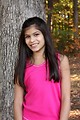 Free Stock Photo: A beautiful young girl posing outdoors by a tree