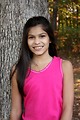 Free Stock Photo: A beautiful young girl posing outdoors by a tree