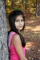 Free Stock Photo: A beautiful young girl posing outdoors by a tree