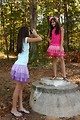 Free Stock Photo: Two cute young girls playing with a camera outdoors