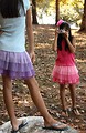 Free Stock Photo: Two cute young girls playing with a camera outdoors